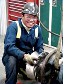 Millwright smiling and working