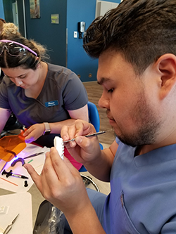 two dental assisting student working on orthodontics