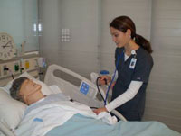 nurse checking on patient bedside
