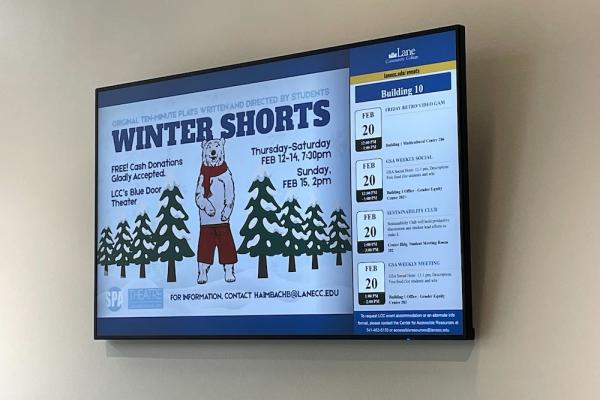 an LCC digital sign displayed on a large flat screen tv in the art building entrance advertising Winter Shorts, small plays put on by the theatre department