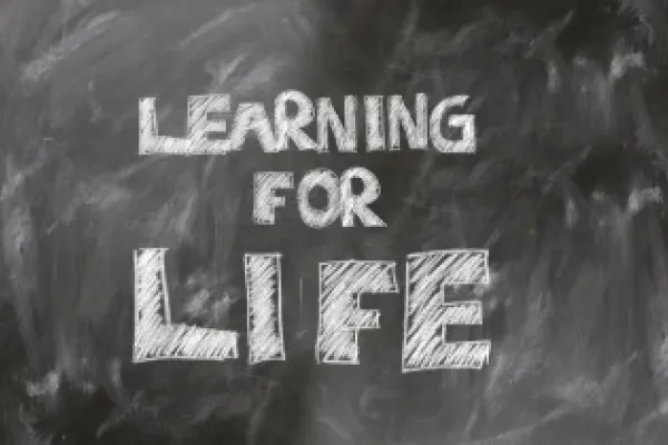 Learning for life written on a chalkboard.