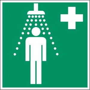 a green and white pictogram of a person under a shower with a first aid cross indicating an emergency shower location