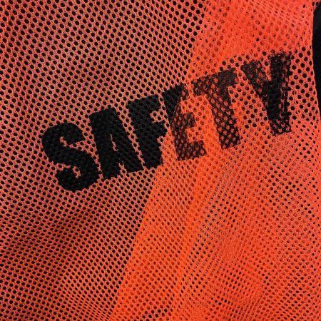 An orange safety vest, with the words safety on it
