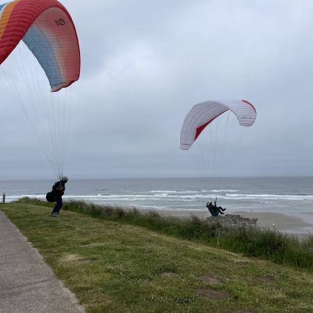 Two paragliders on a coastal, northwest looking beach